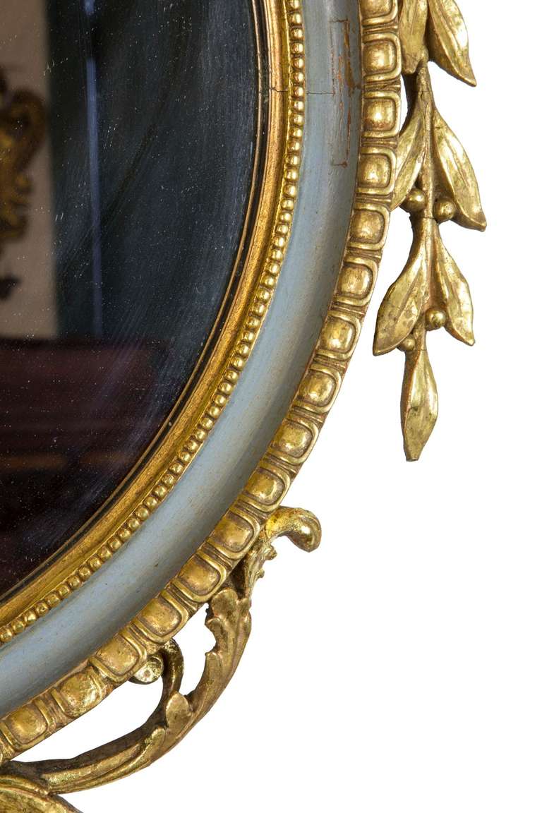 This mirror retains its magnificent gilt surface, the embellishments are superb, and the tall, vertical nature of the mirror makes it quite serviceable for a space with limited width, as it is 46 1/2 in. high and only 21 3/4 wide.

The mirrored
