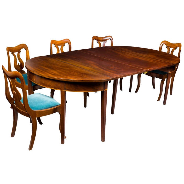 This table is in fabulous condition throughout and is composed of magnificent solid unjoined mahogany boards exhibiting striking ribboned or figured mahogany. The top board of the table are heavy and are of dense Cuban mahogany. The skirt has a very