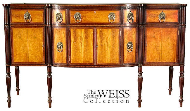 This sideboard is a tour de force of vibrant flame birch contrasted against deep mahogany and offset with beautiful inlay similar in type to those used by the renowned Seymours in Boston. While this sideboard is not a Seymour piece, because of