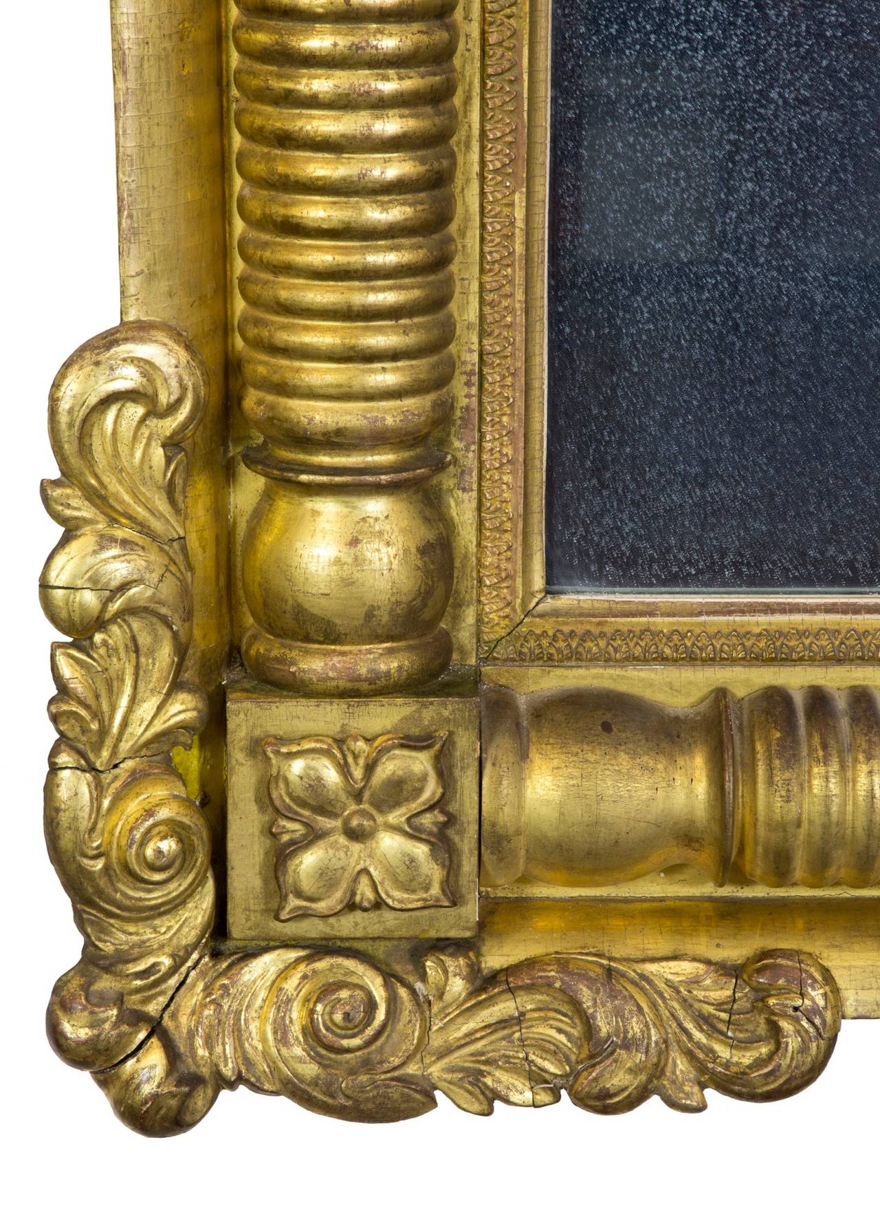This commanding mirror is a standout and has a beautiful surrounding frame with carved edges, which is seldom seen. At this period, the use of reverse paintings on top was no longer fashionable, and they were all of glass, which is original in this