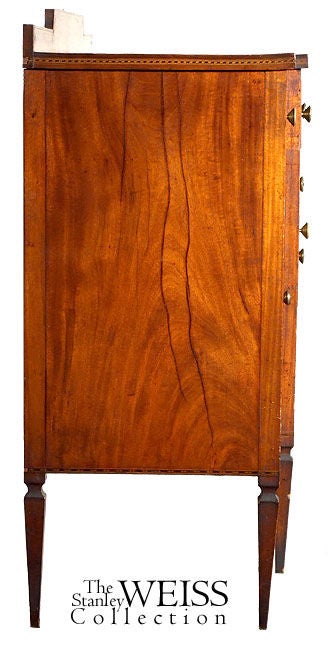 This small-scale sideboard has fabulous paneled doors and drawers of crotch mahogany that have developed a remarkable golden brown patina over time. It is interesting to note that while many of these sideboards are quite deep, this one is very