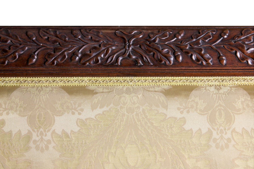 Classical examples of Phyfe's sofas come to market from time to time in varying states of condition. This example is the only one we have found with complete carving from one end of the crest rail to another. The carving is all of acorns and is