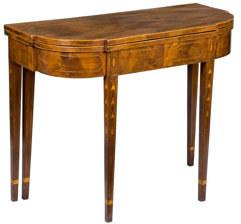 This is a finely crafted high style New York card table of quality. Of note is that there is an extra leg which swings out as opposed to one of the rear “stationary legs” supporting the hinged leaf. This 5th leg is a desirable and rare design, which