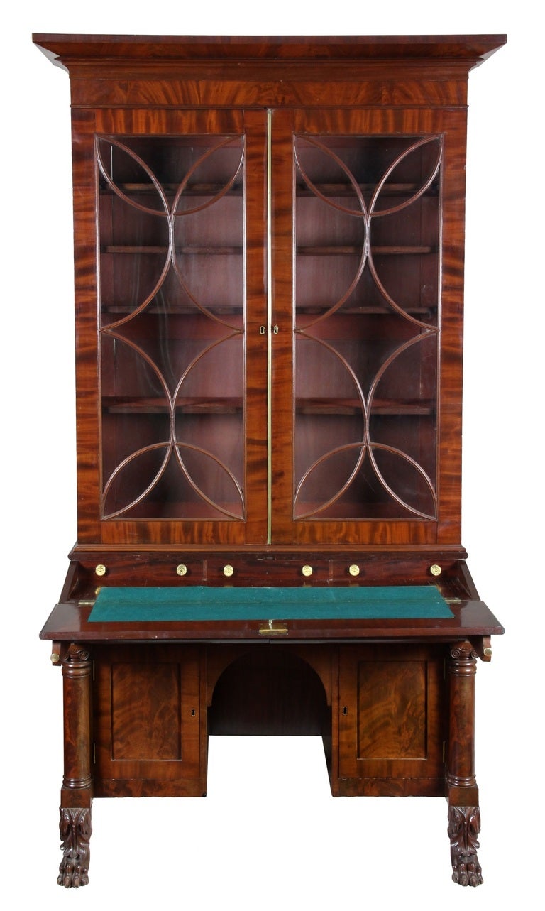This secretary, with its kneehole desk, and large lid for writing, makes it a well thought-out secretary designed to be used. The columns and paw feet are well-carved with great attention to detail; see the scrollwork on top of the column. The most