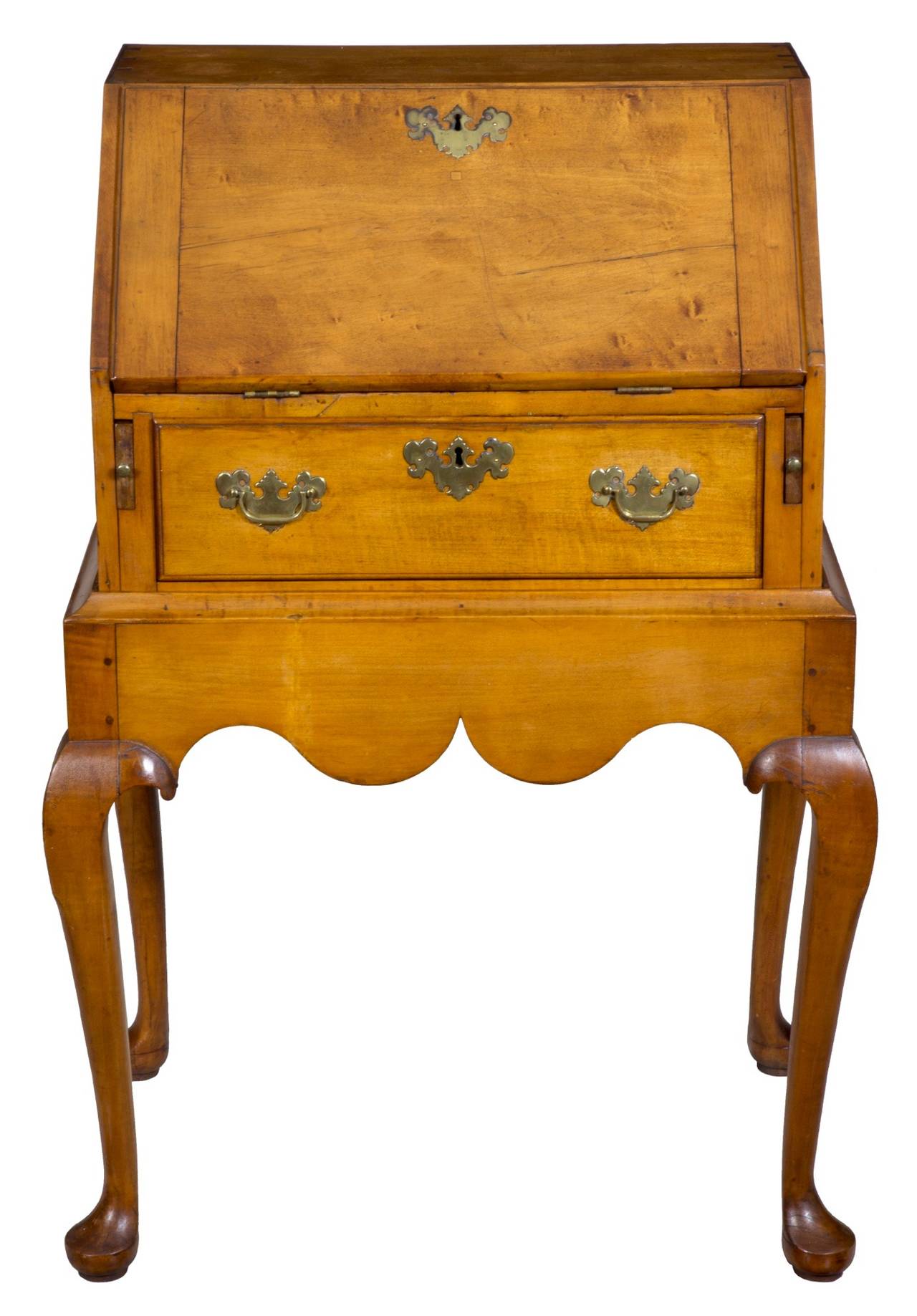 Whether a lady’s desk or a child’s desk, what it is an early diminutive desk based on the design of a frame receiving a small desk. The form in the upper knee of the carved Queen Anne leg is quintessential Salem. The skirt is of beautifully Queen