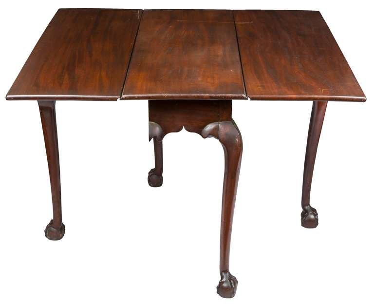 This is a delicate, mid-sized drop-leaf table. The thickness of the mahogany on the top gives this table a slender feeling, as do the long cabriole legs with their magnificent arching and good-sized claw and ball feet, all of which says “Look at me!