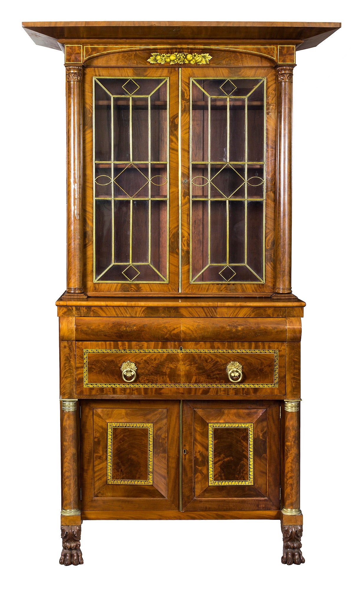 Case pieces of this type are often designed as secretary desks, but this example offers one large drawer beneath two small convex drawers and raised panel doors with stencil work typical of the Haines & Holmes shop in New York. This piece retains