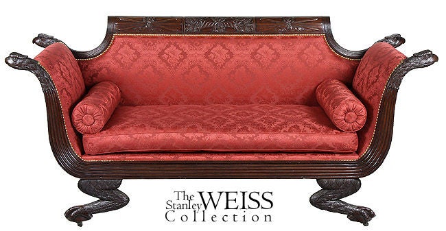 This is a phenomenal settee with exuberant carving throughout. It appears quite animated with eagle heads at the ends of each arm followed by beautifully developed reeding, all of which is supported by very distinctive carved claw and ball feet.