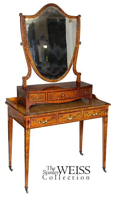 This is a large size dressing mirror, unquestionably early 19th century and of striking satinwood with painted floral decorations throughout. Because these are fragile forms, few have survived. This mirror, on the back of the frame has old ironwork