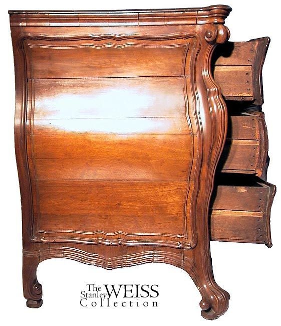 This commode has an extremely well-developed serpentine (or bombe) shape not only in the front, but also developed along its sides. It is a beautifully sculptured early piece of monumental proportion. It was acquired in Newport, RI. There are no