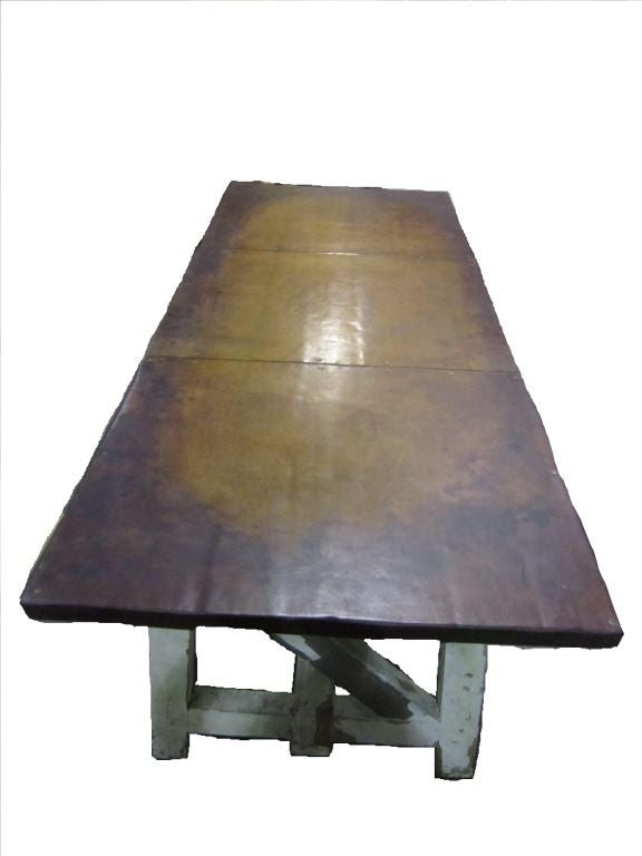A Distressed Wooden Leather Toped Table