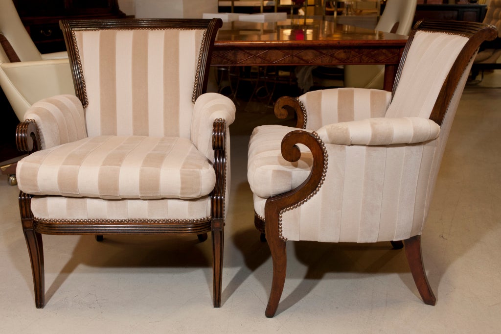 Pair of beautifully carved walnut armchairs. Curved reeded back with scrolled arms. French polished and reupholstered.