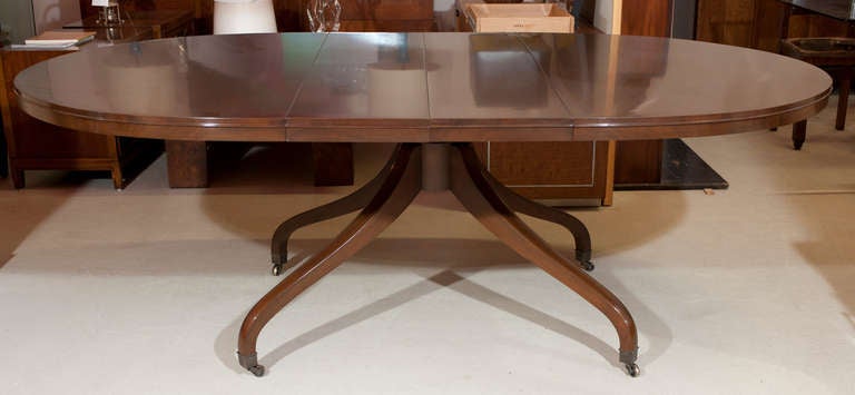 Oval Mahogany 2 leaf dining table with an incredibly handsome pedestal base. Refinished and hand rubbed. Original runners work very well. Each leaf is 12
