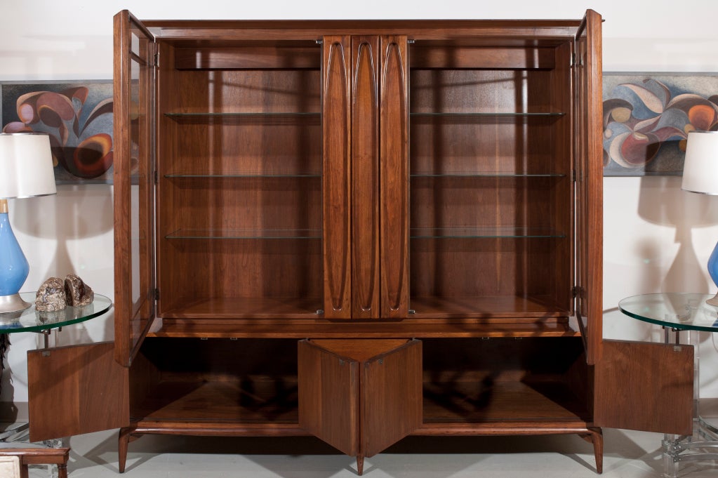 Amazing large scale mahogany mid century cabinet with 2 georgous glass and bevelled wood doors. Top sits on 4 door / 2 drawer lower cabinet. Hidden handles inside the arches.