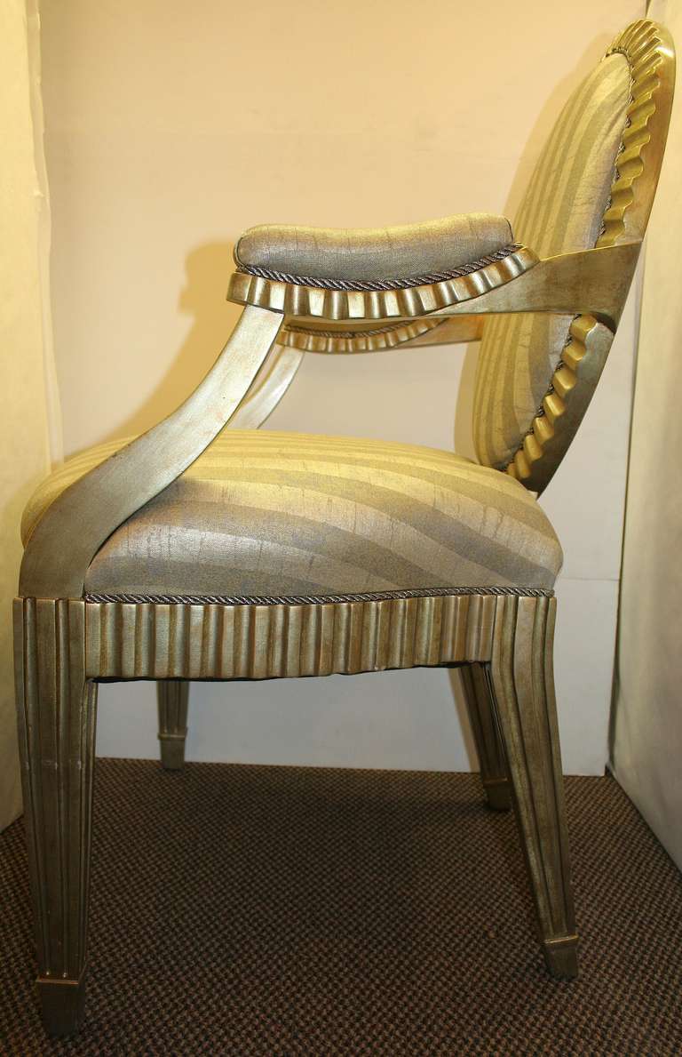 Set of four Donghia arm chairs with gilded details and striped fabric