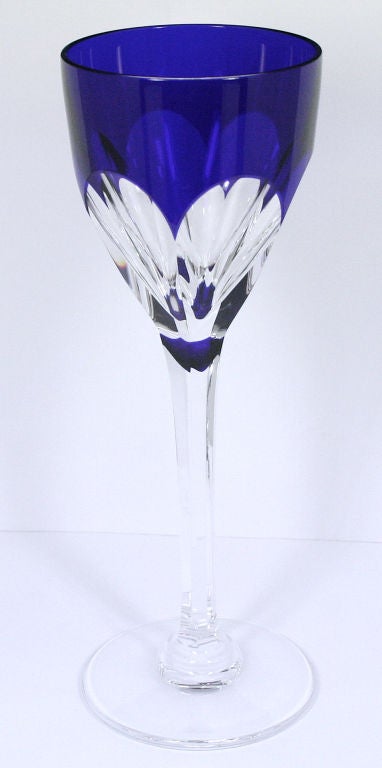 One of the most luxurious brands of stemware available today, this is a Saint Louis crystal hock wine glass. The cut is referred to as “Bristol”. The bowl of the glass is cobalt blue cut to clear on six facets. The cut is extended to the stem.<br