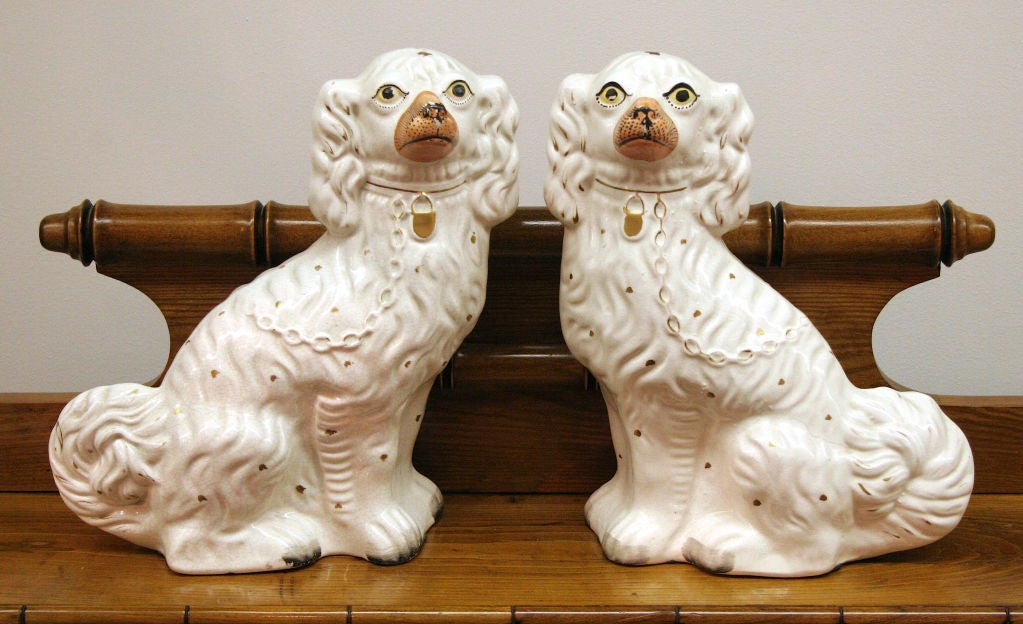 Great pair of traditional Staffordshire dogs.  This pair is in the all white glaze that seems to be the most prevalent.  They are over sized and in great shape.