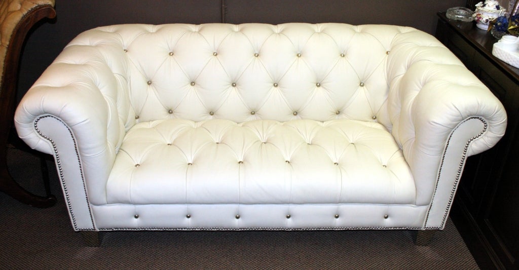 Great designer piece, we love white leather, such a great color to assimilate into your design scheme and know that it works in almost any environment.Great shiny tufting and mirrored feet add to the uniqueness of this beauty. This is a decorator