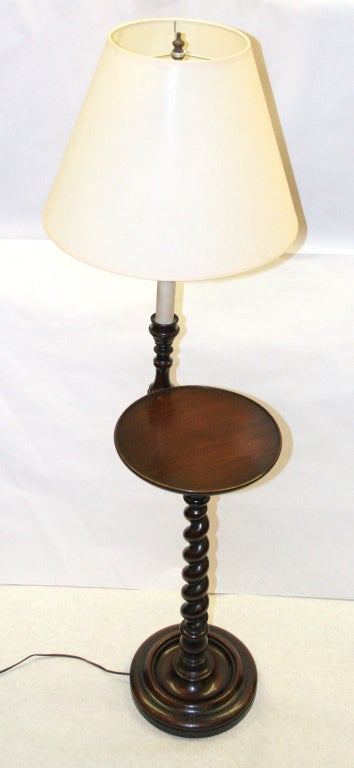 Its the old tried and true barley corn twisted mahogany standing lamp with a very convenient surface for your favorite book and a nice cup of tea. Very traditional and always in demand. This one is very nice