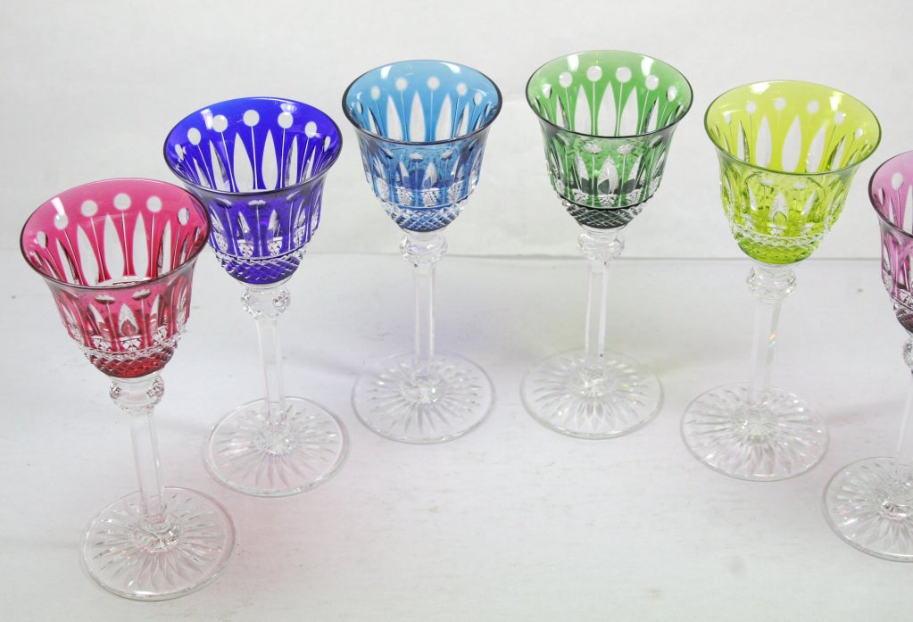 Collection of Saint-Louis crystal Tommy sherry glasses in amethyst, chartreuse, blue, sky-blue, green and red.