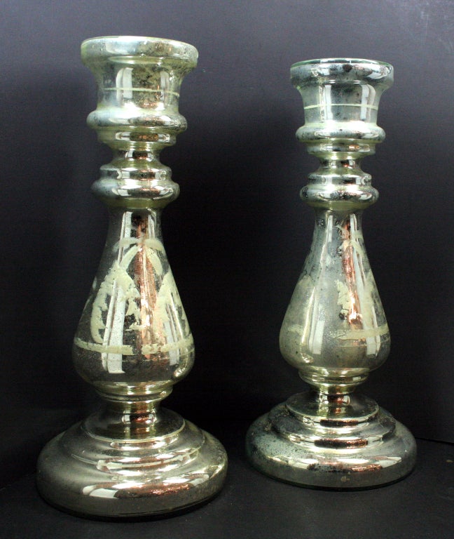 Pair of mercury glass candlesticks with painted details