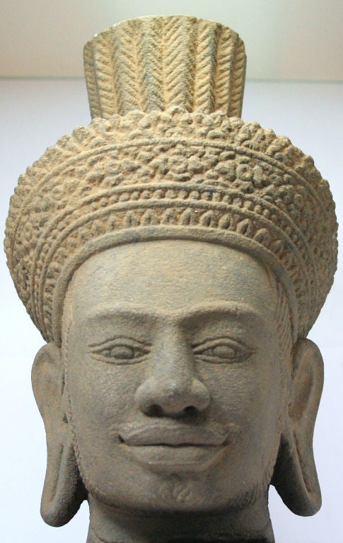 Sandstone head of Avalokiteshvara or Vishnu, early Khmer style, c 10th/11th century.<br />
<br />
Some original pigment visible, appx. 9