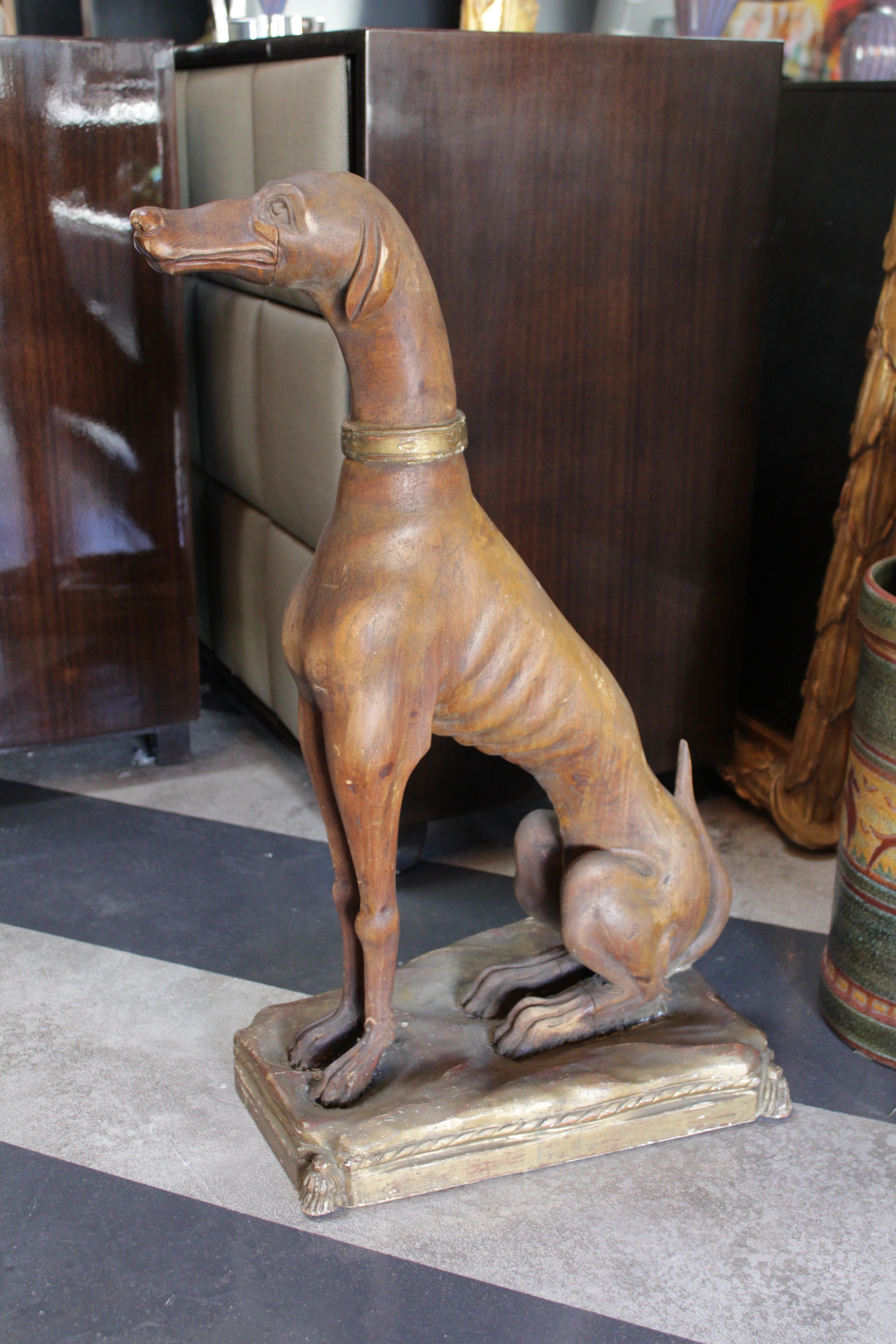Italian hand-carved wooden dog. Beautifully detailed and perfect for any room, especially a study or den. There is a hole on the dog's head, as he used to hold a tray. The dog sits upon a hand-carved pillow. The perfect pet. Always seated in great