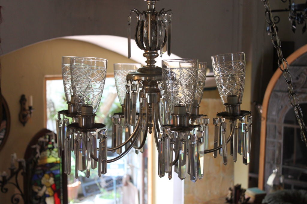 Silver metal finish five light with rectangular prisms and cut glass hurricanes make this lovely fixture distinctive.