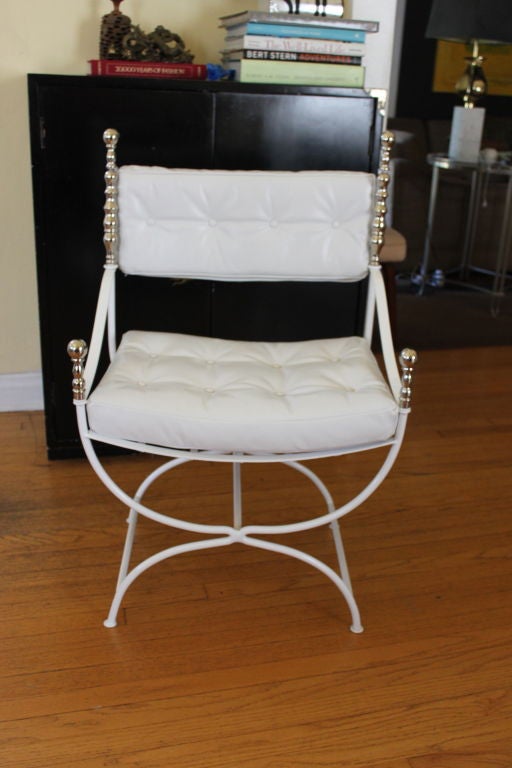 Throne chair powder coated in white with nickel-plated finials and white leather upholstered cushions.