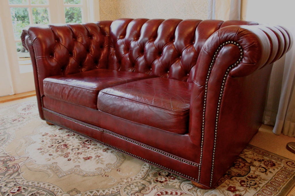 Impressive 5' Chesterfield love seat in burgundy leather - wonderful in a traditional setting, stunning as a mix to contemporary