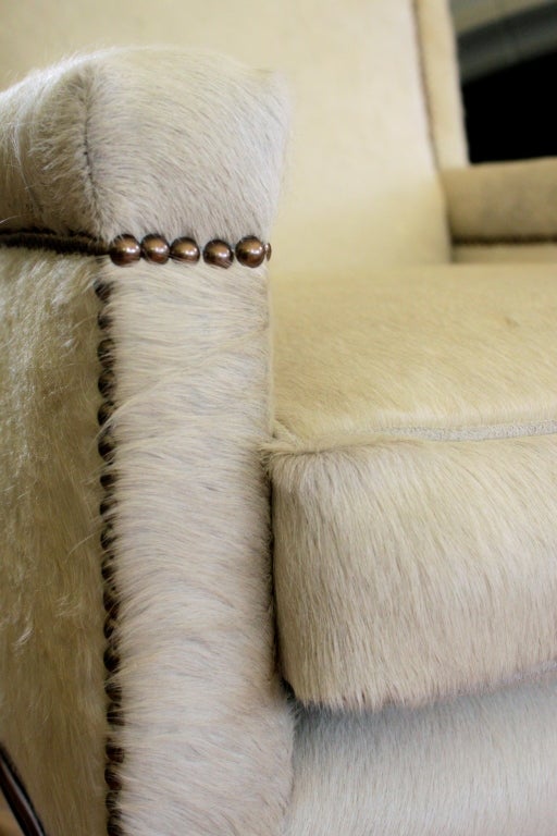 Pair of off white pony skin chairs with hoof detail leg