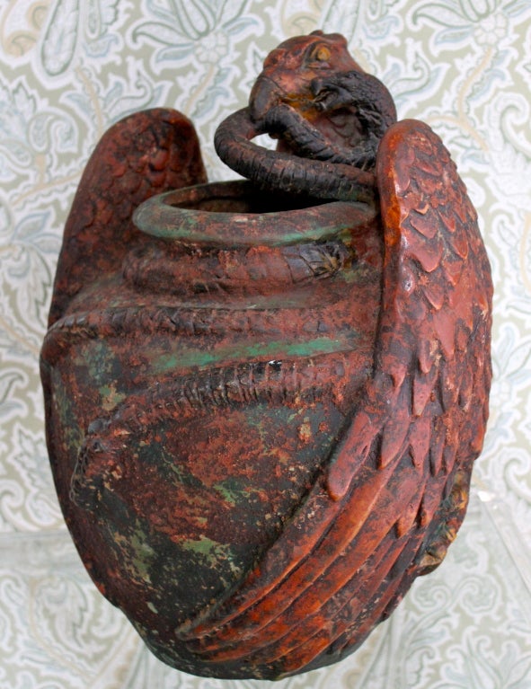 Clay sculpted eagle pot with snake in mouth, snake has detailing of wire tongue.