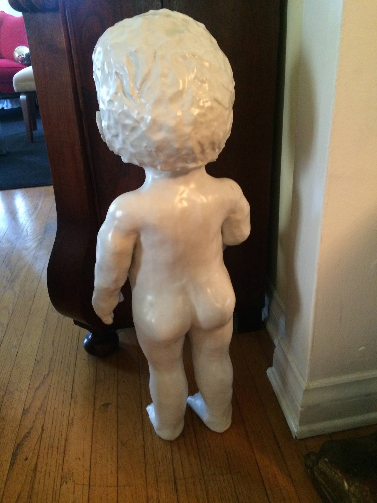 Life-sized porcelain figure of a boy stands on its own. A very heavy and substantial piece. An interesting idea for the garden!