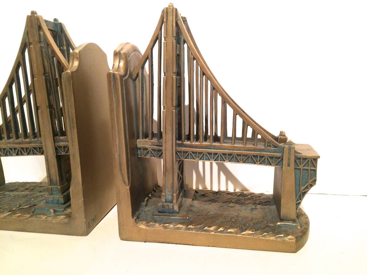 Pair of gilt golden gate bridge bookends. These appear to be plaster and in great vintage condition. Perfect for the library, study, kids room or perhaps your favorite city!