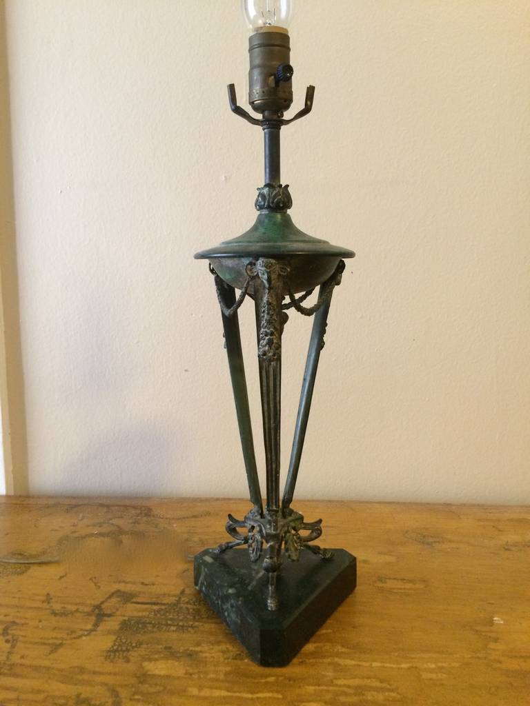 Cast bronze lamp with whimsical animal feet. The triangular base is green marble. The lamp is from the early 1980s and made by Lyle and Umbach.
Perfect to place on a front hall table or side table.