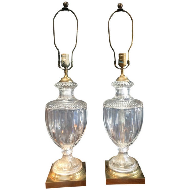 Pair of glass table lamps with a square brass base. Silk shades with ribbon trim come with these lamps - shades are not in perfect condition.