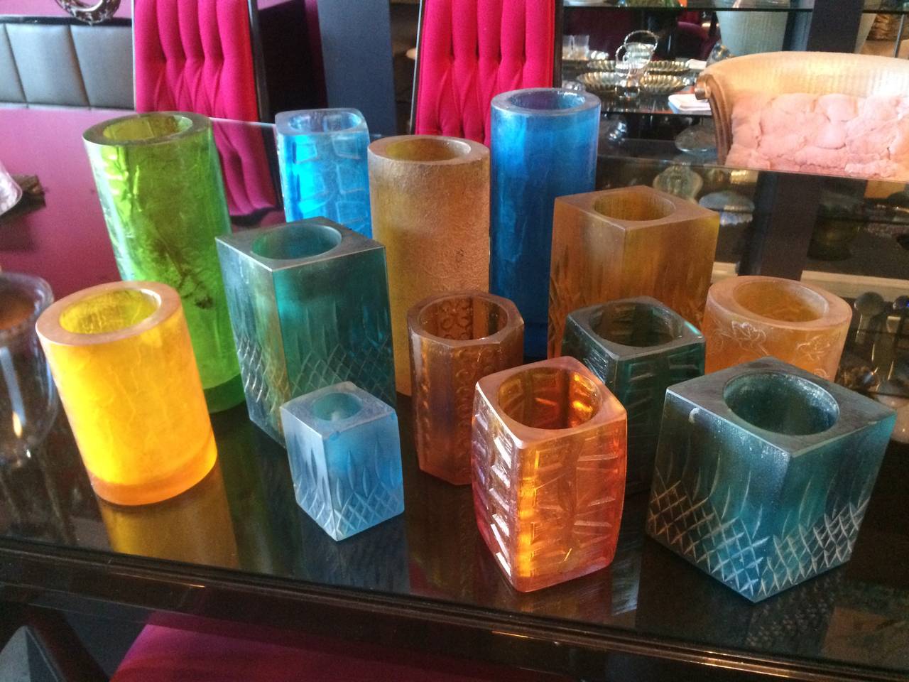 13 total Sascha Brastoff signed candleholders. Made of resign with motifs from graphics to grapes and in three different sizes, purchase large for 200.00,
medium 175.00 and small for 125.00. The tall and large hold the tall religious sized candles,