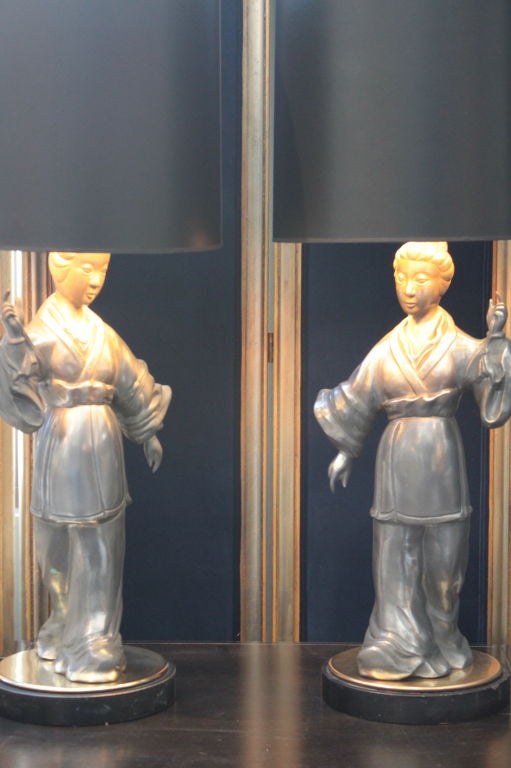 Pair of beautiful Asian zinc figurative lamps with brass bases and finials.
