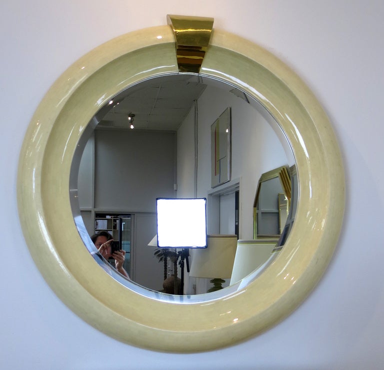 Monumental tessellated bone mirror with a large brass  'keystone'. Unsigned, in the style of Karl Springer. Beveled mirror. set into deep shaped surround.