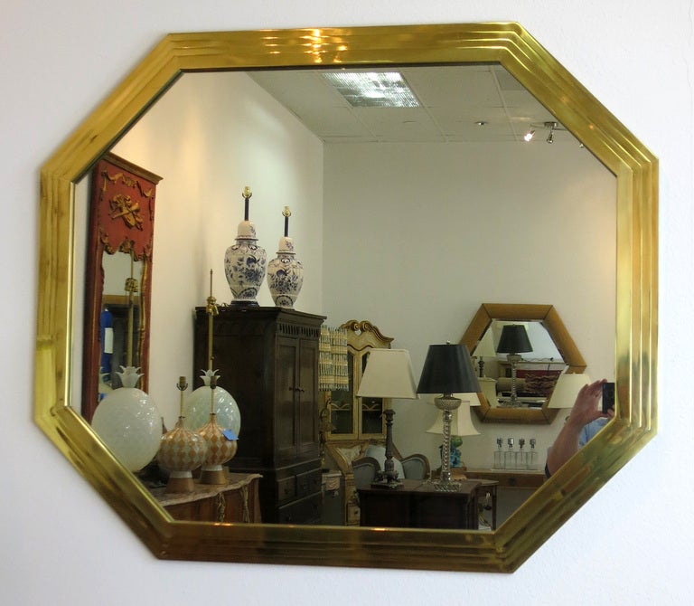 Octagonal form mirror with a steeped brass frame. Great quality and a wonderful sculptural form. May be hung vertically or horizontally