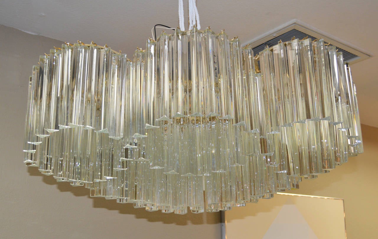 Unique and sculptural crystal chandelier by Camer Glass comprised of undulating bands of prisms.