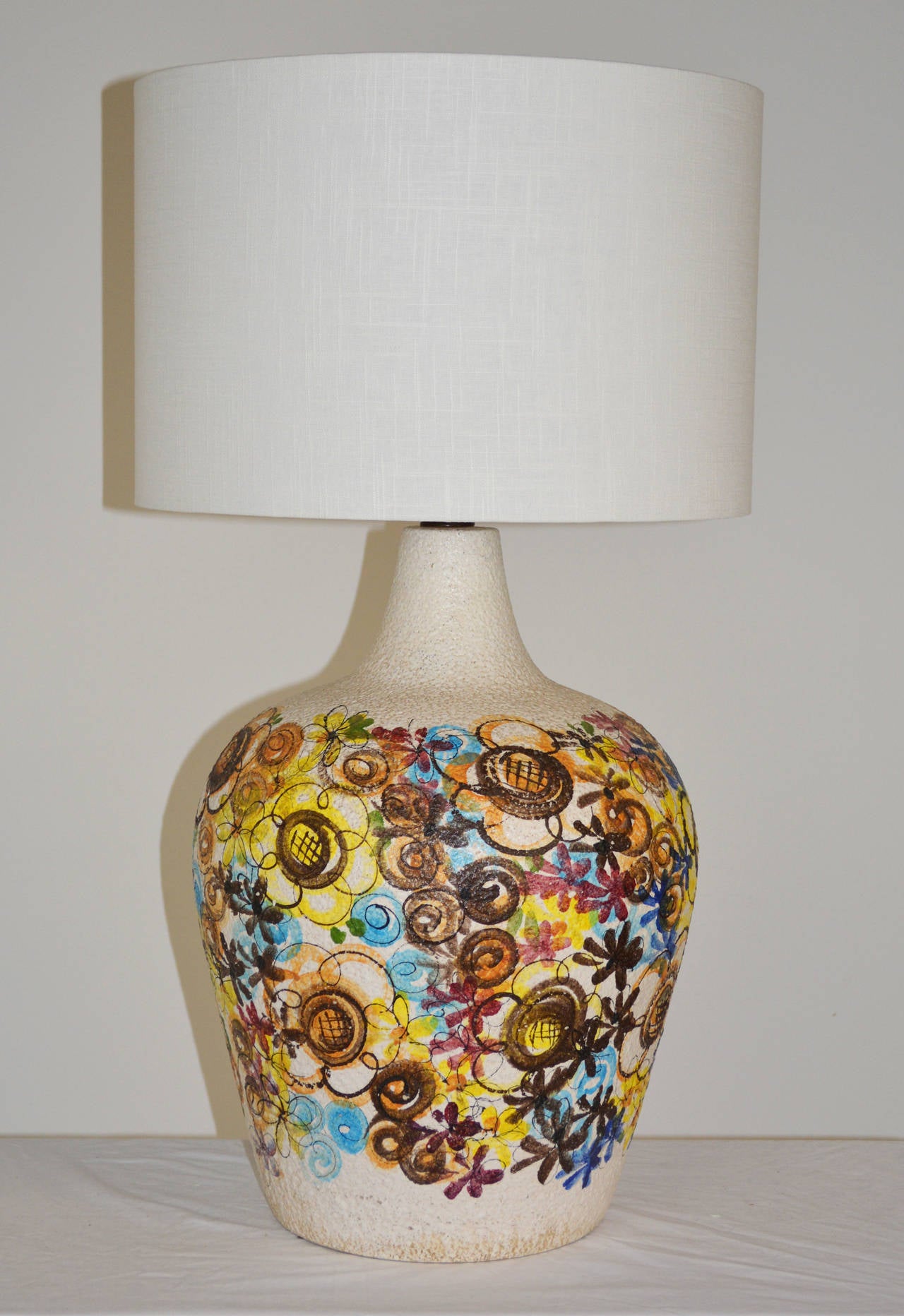 An amazing large scale pottery lamp with hand painted floral decoration. 26'' to top of socket, 34'' to top of shade as shown. Shade for display only.