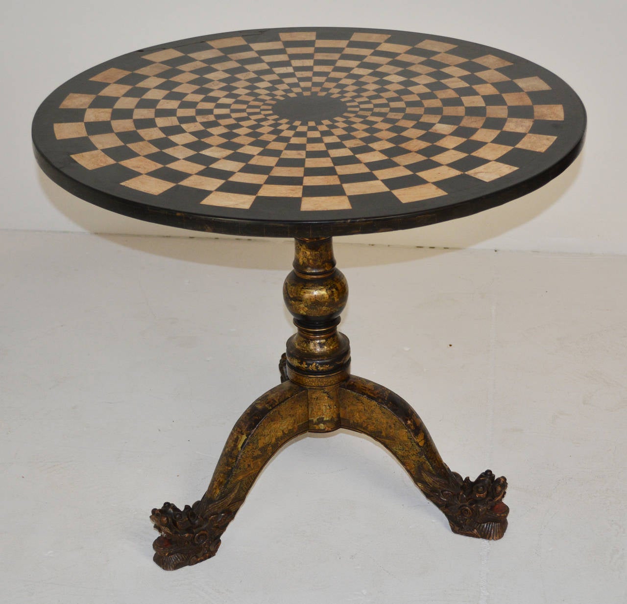 An exceptional 19th century English tripod table with a mosaic marble and slate intarsia top on a turned and carved baluster support terminating in a dragon-motif carved tripod base; of black and red lacquer grounds with gilt decoration of figural