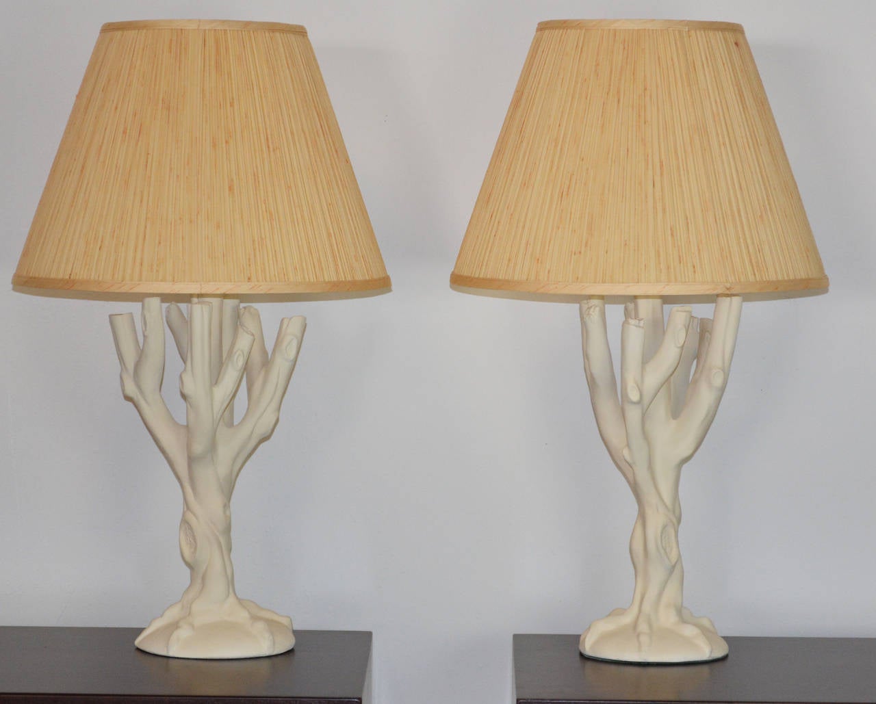 A pair of plaster tree form lamps in the style of John Dickinson. A lovely form with original finials.
Shades are for display only.