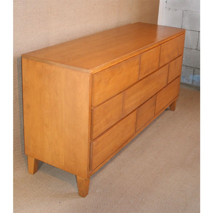 Elegant dresser designed by Russel Wright for the "Modernmates" line for Conant Ball. Maple cabinet with nine drawers, original finish, signed with burned mark in drawer.