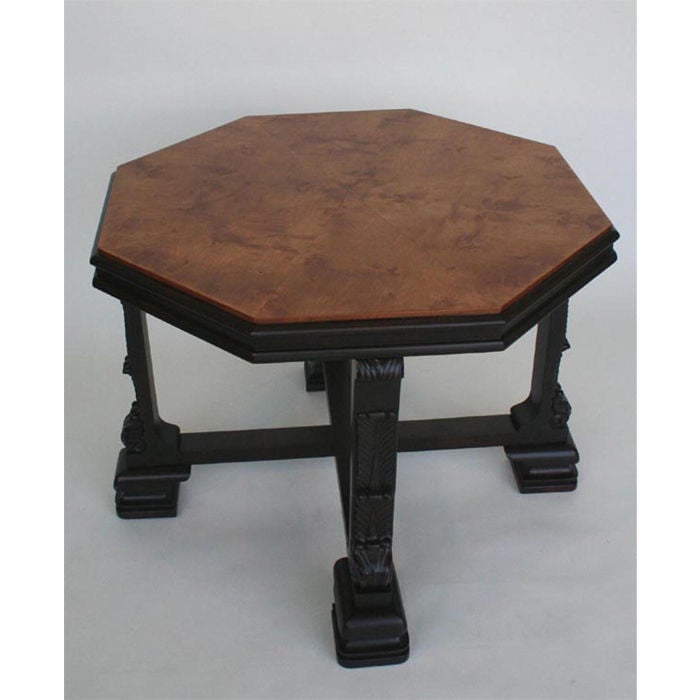 Octagonal table with bookmatched Birch veneer top on an ebonized, carved wood base. Unique scroll palmettes on legs show the art deco influence of the period.