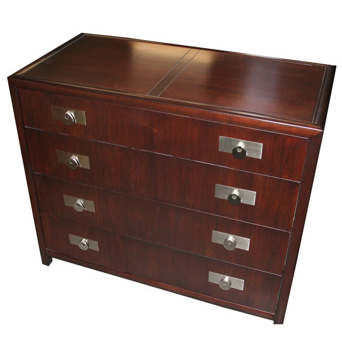 Elegant chest of drawers by Michael Taylor for Baker Furniture. Dark stained cherry with nickel plated pulls. Finished on all four sides.