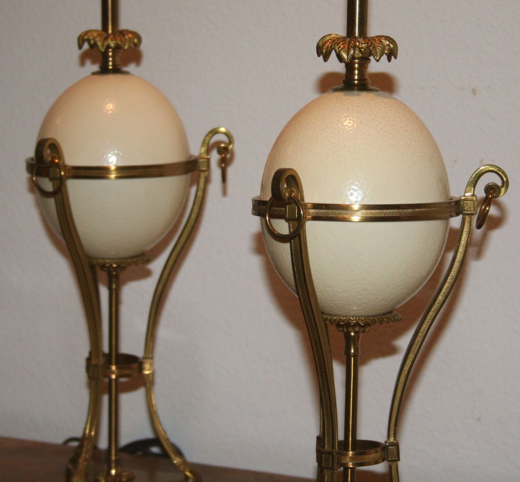 Chic pair of gilt bronze neoclassical lamps centered on Ostrich eggs, Signed on bottom by Maison Charles. Great quality, wonderful detailing.