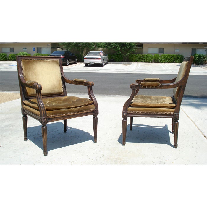 Pair of good Louis XVI style fauteuil with original bronze velvet upholstery and nailhead trim. Nice carving, good proportions. Seat cushion is button tufted and semi-attached.