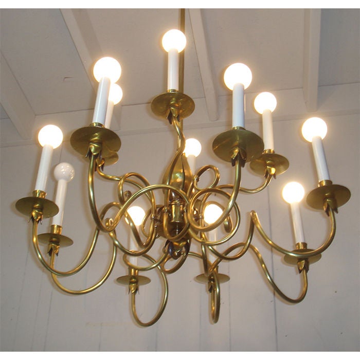 an elegant modern take on a traditional chandelier. Gracefully curving arms spiral from the floral "pod" shaped central support. Bronze bobeches have similar petal forms. signed Norman Grag.